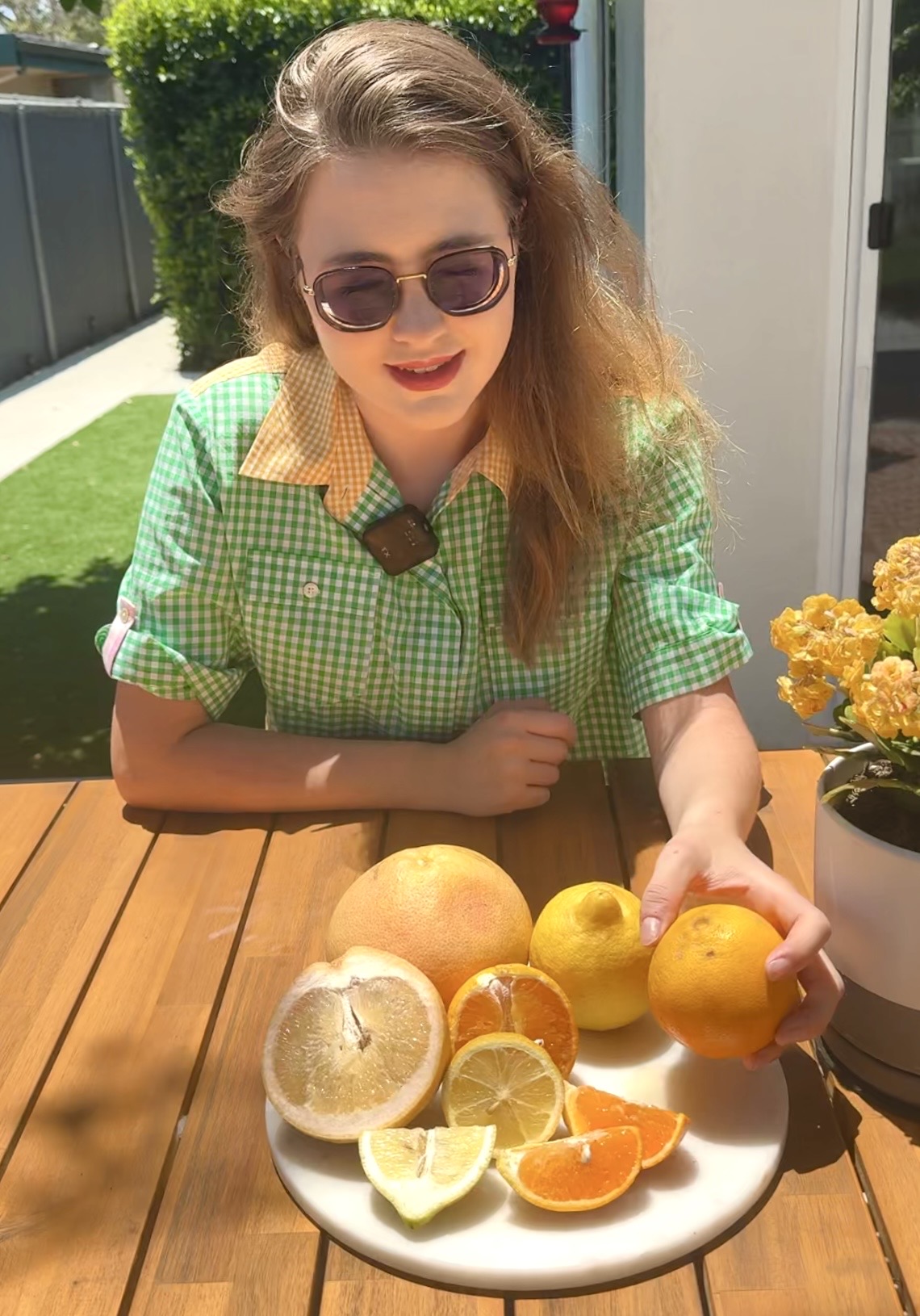 Skyler, a featured PickFresh seller, with citrus from her mini orchard